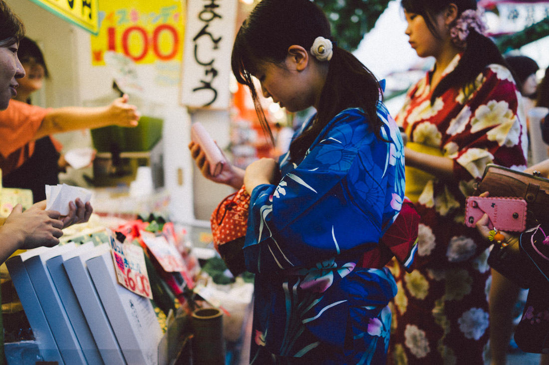 Groups of friends flock the stalls buying little sweets and drinks.