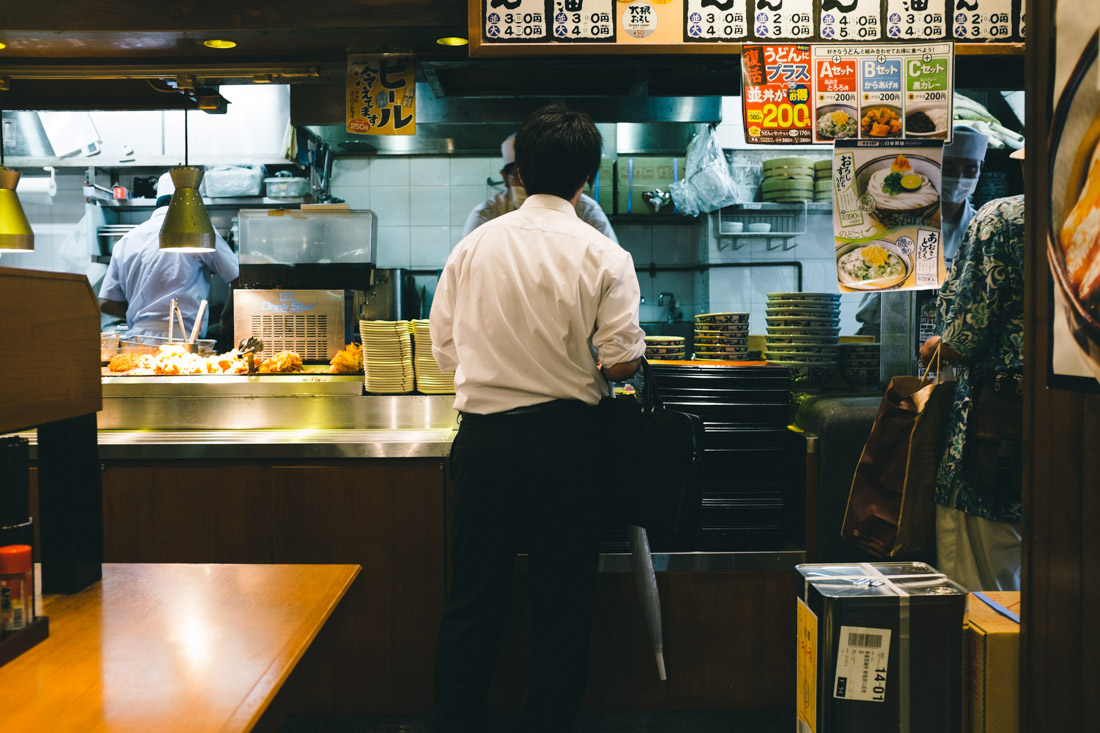 Japanese salaryman ordering his — much overdue, we presume — dinner