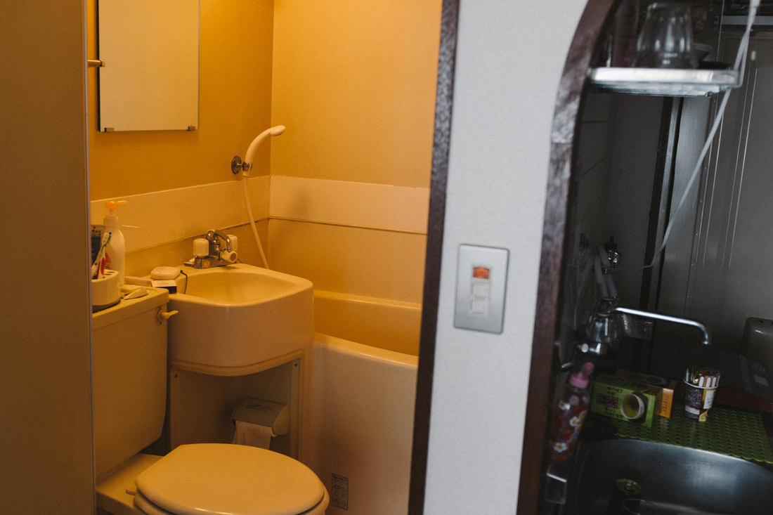 Bathroom and kitchen separated by a thin wall