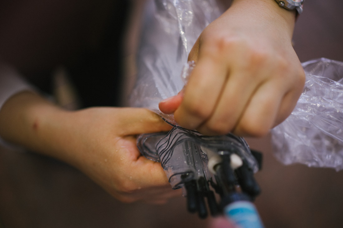 You don’t walk with wet umbrellas inside stores, so they usually have plastic bags to put them into. Here, a BIC Camera employee helps us with that.