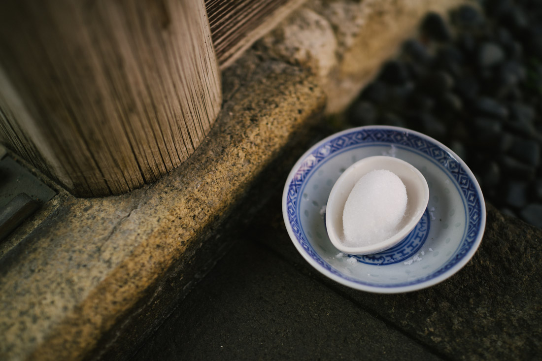 Every restaurant in this discrict has a custom of leaving a plate with sugar (?) at the entrance.