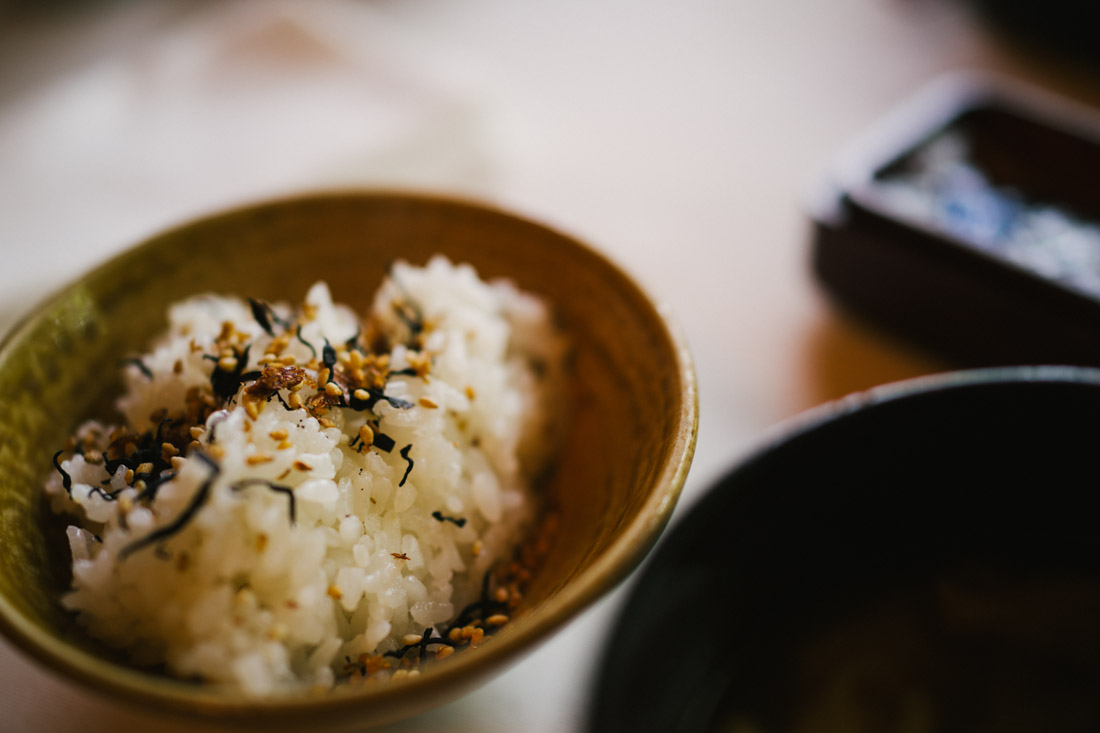 Rice topped with seaweed and sweet sesame seeds.